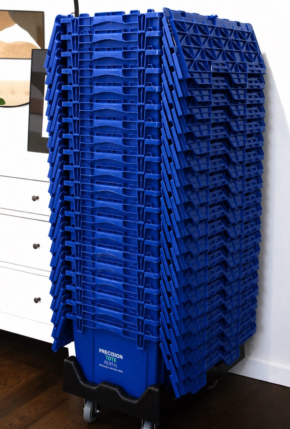 Nested blue moving totes stacked on a dolly indoors